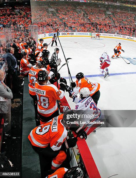 Zac Rinaldo of the Philadelphia Flyers collides in front of the bench against Mats Zuccarello of the New York Rangers in Game Three of the First...