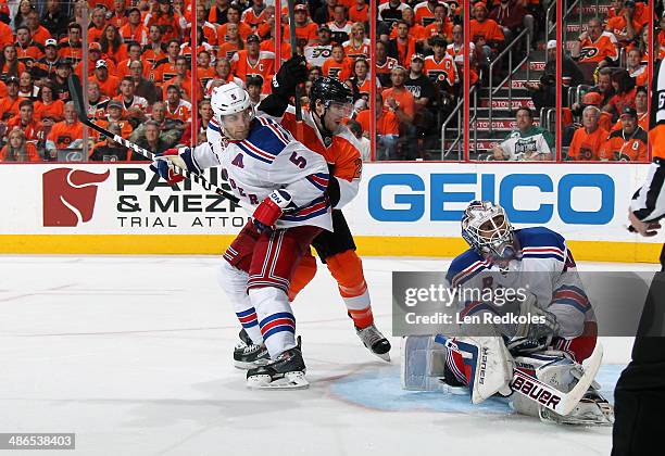 Matt Read of the Philadelphia Flyers battles in the crease against Dan Girardi and Henrik Lundqvist of the New York Rangers in Game Three of the...