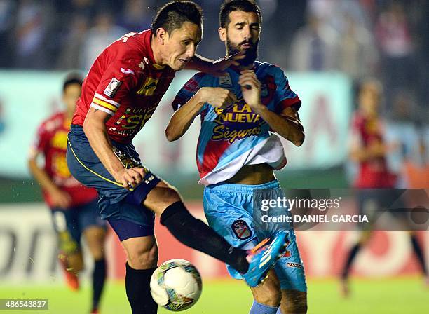 Chile's Union Espanola forward Gustavo Canales vies for the ball with Argentina's Arsenal defender Mariano Echeverria during the Copa Libertadores...