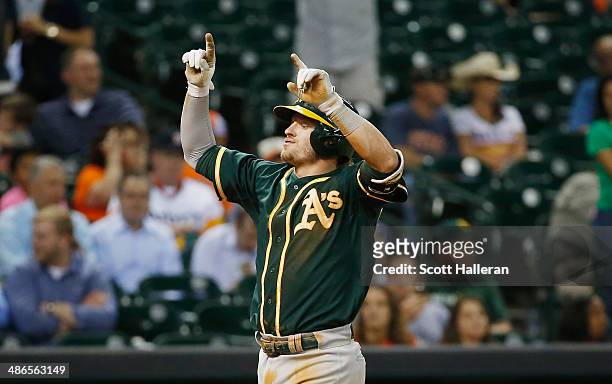 Josh Donaldson of the Oakland Athletics celebrates after his two-run home run in the seventh inning of their game against the Houston Astros at...
