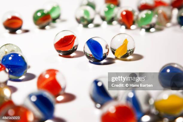 coloured marbles on a white background - hans barten stockfoto's en -beelden