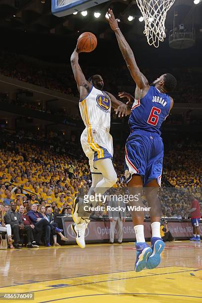 DeAndre Jordan of the Los Angeles Clippers blocks a dunk against Draymond Green of the Golden State Warriors in Game Three of the Western Conference...