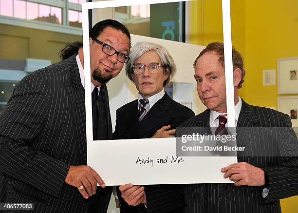 Penn Jillette and Teller of the comedy/magic team Penn & Teller pose with a Madame Tussauds wax figure of Andy Warhol duing the grand opening of the...