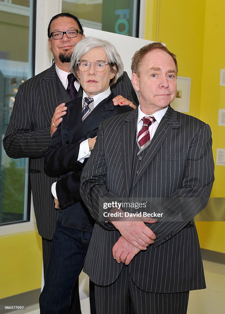 A Madame Tussauds Wax Figure Of Andy Warhol Gets A Visit From Penn & Teller At The Grand Opening Of The Polaroid Museum