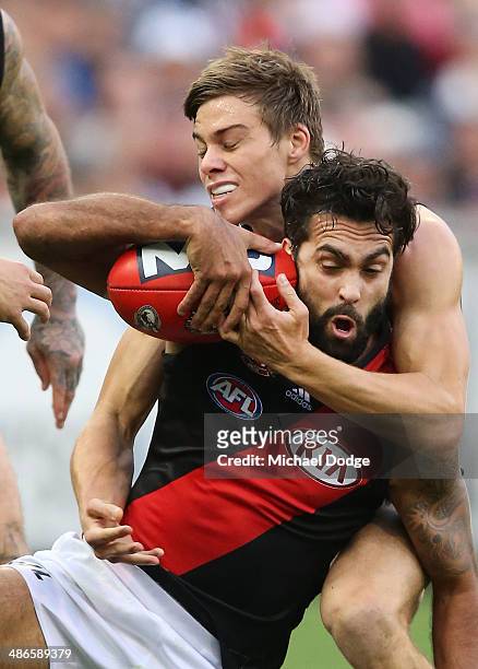 Courtenay Dempsey of the Bombers is tackled by Josh Thomas of the Magpies during the round six AFL match between the Collingwood Magpies and the...
