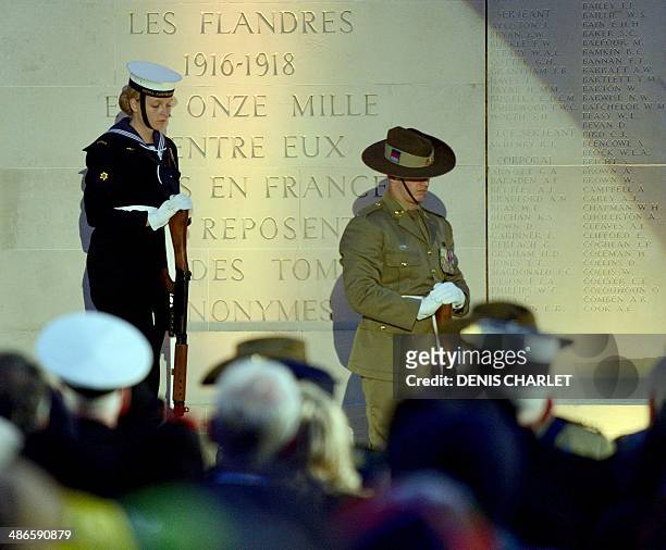 People attend a dawn service at the Australian War Memorial in the northern French city of Villers-Bretonneux, on April 25 to commemorate the 99th...