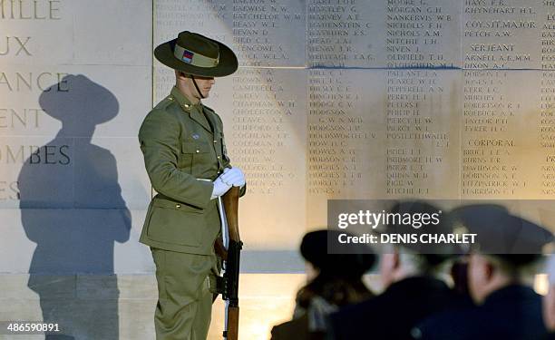 People attend a dawn service at the Australian War Memorial in the northern French city of Villers-Bretonneux, on April 25 to commemorate the 99th...