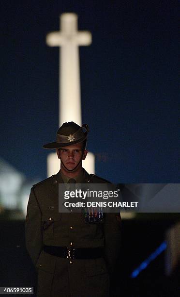 Australian soldier stands during a dawn service at the Australian War Memorial in the northern French city of Villers-Bretonneux, on April 25 to...