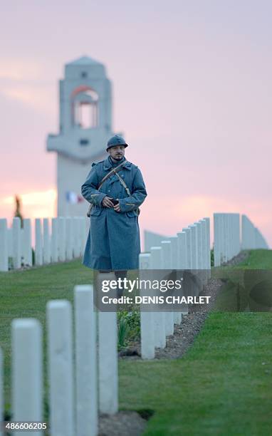 Man dressed as French soldier of the First World War walks during a dawn service at the Australian War Memorial in the northern French city of...