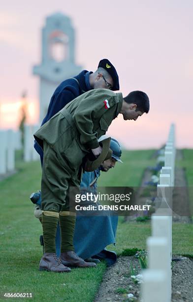 Men dressed as French soldier of the First World War look at names on graves during a dawn service at the Australian War Memorial in the northern...