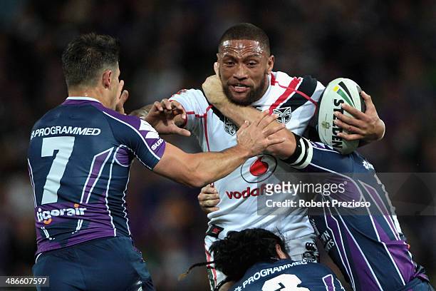 Manu Vatuvei of the Warriors is tackled by Cooper Cronk of the Storm during the round 8 NRL match between the Melbourne Storm and the New Zealand...