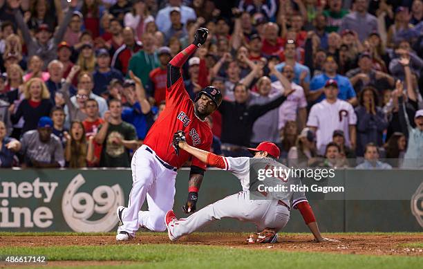 David Ortiz of the Boston Red Sox scores as he slides and avoids the tag of Jeanmar Gomez of the Philadelphia Phillies during the seventh inning...