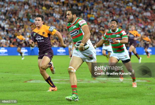 Greg Inglis of the Rabbitohs breaks away from the defence to score a try during the round 8 NRL match between the Brisbane Broncos and the South...