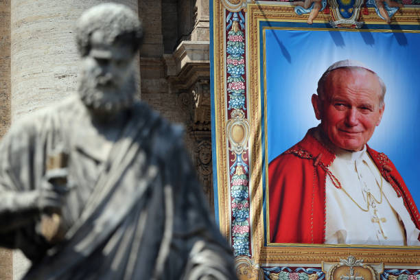 Tapestry depicting the late Pope John Paul II hangs on the balcony of St Peter's basilica on April 25, 2014 in Vatican City, Vatican. The late Pope...
