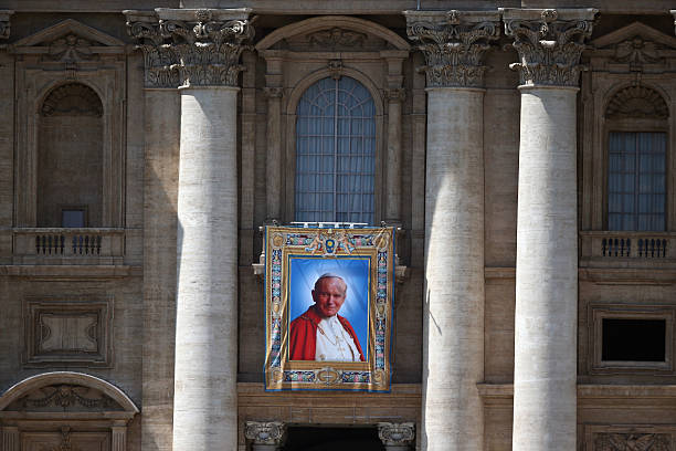 Tapestry depicting the late Pope John Paul II hangs on the balcony of St Peters basilica on April 25, 2014 in Vatican City, Vatican. The late Pope...