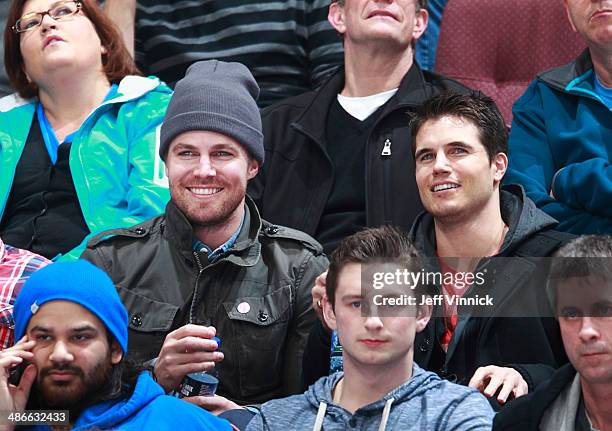 Actors Stephen Amell of the show Arrow and Robbie Amell of the show The Tomorrow People watch the NHL game between the Vancouver Canucks and the Los...