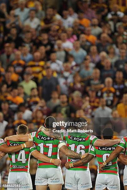 Rabbitohs players stand in silence as an Australian Soldier plays the Last Post to mark Anzac Day before the round 8 NRL match between the Brisbane...