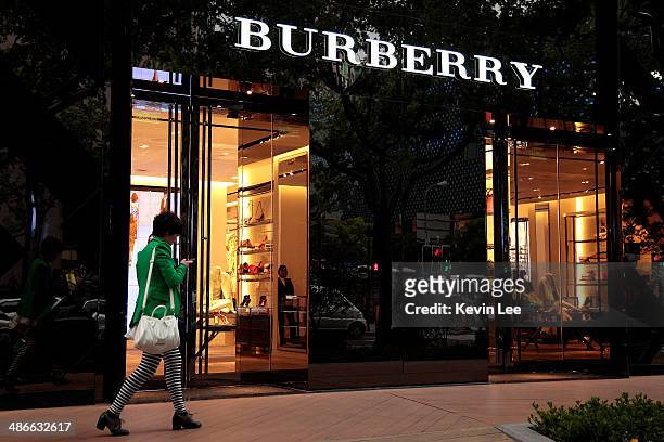 Woman walks in front of Burberry's new flagship store on April 25, 2014 in Shanghai, China.