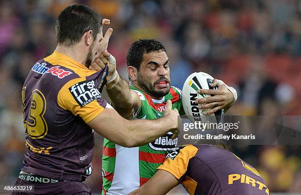 Greg Inglis of the Rabbitohs tries to push away from the defence during the round 8 NRL match between the Brisbane Broncos and the South Sydney...