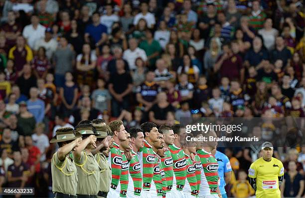 South Sydney players embrace for the national anthem of Australia during the round 8 NRL match between the Brisbane Broncos and the South Sydney...