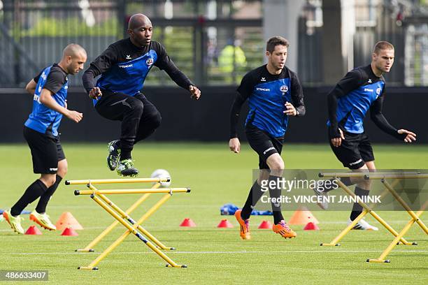 Dutch football club Heracles player Kwame Quansah jumps during a training session in Almelo on April 25, 2014. Heracles Almelo play Ajax Amsterdam in...