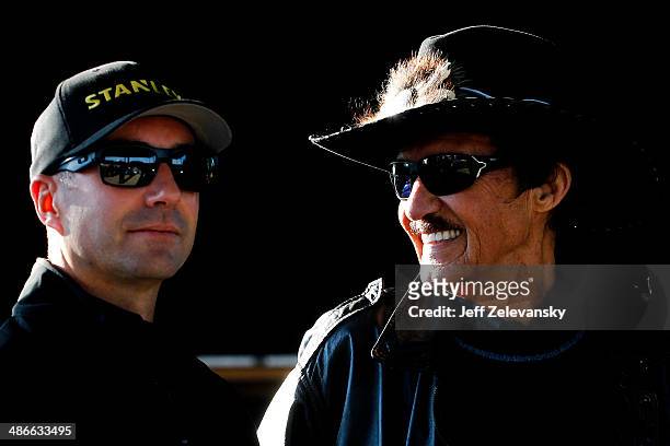 Hall of Famer Richard Petty and Marcos Ambrose, driver of the Stanley/Ace/CMN Ford, look on during an autograph signing at Richmond International...