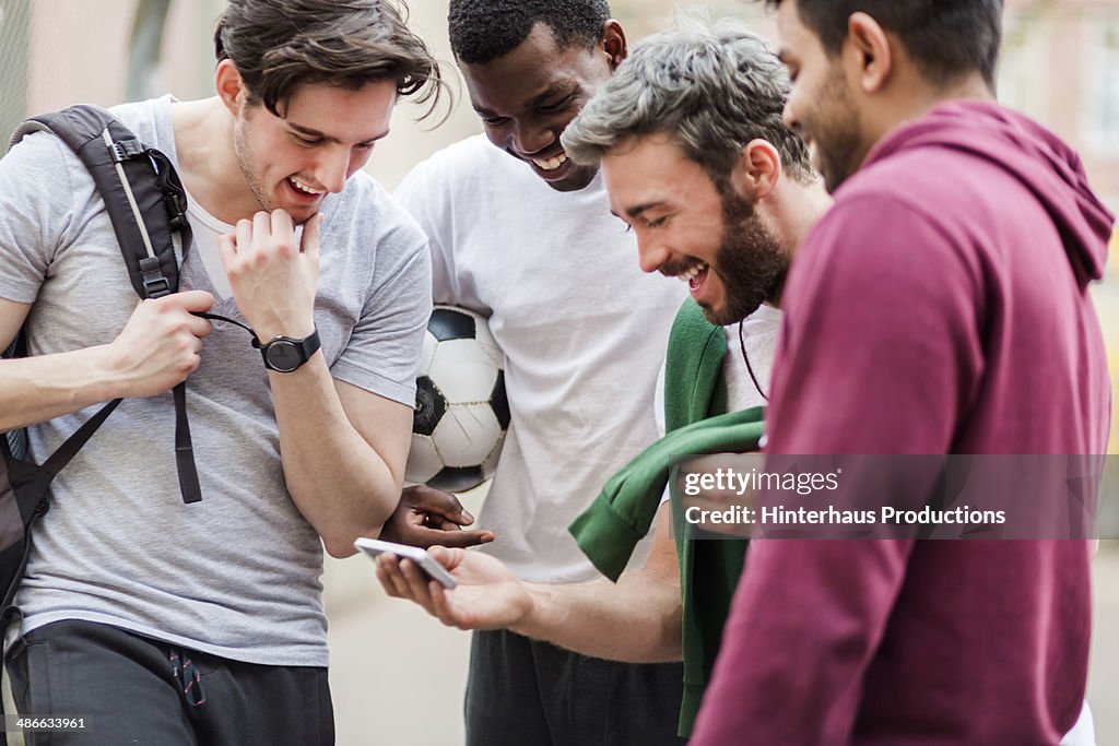 Sports Guys With Smart Phone Having Fun