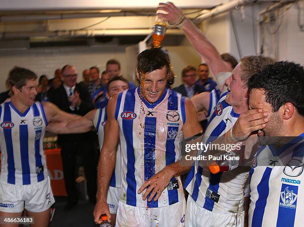 Joel Tippett of the Kangaroos celebrates with team mates after winning the round six AFL match between the Fremantle Dockers and the North Melbourne...
