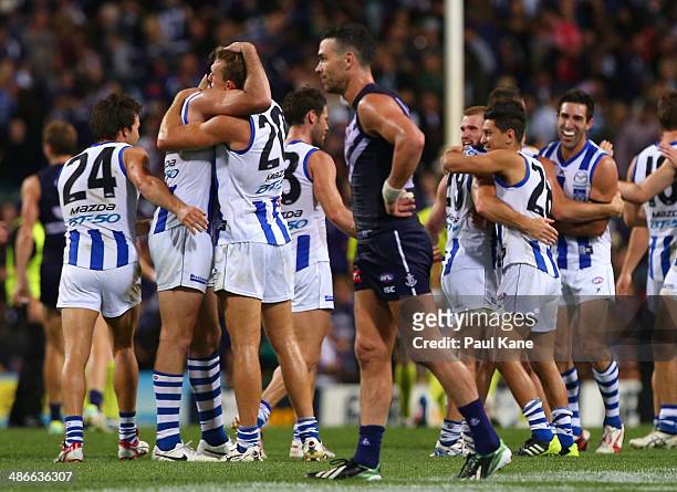 Drew Petrie of the Kangaroos celebrates winning and playing his 250th game with team mates during the round six AFL match between the Fremantle...