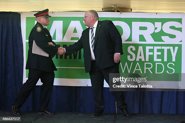 Mayor Rob Ford and Toronto Police Inspector Randy Carter on stage at the Community Safety Award winners at City Hall in Toronto, April 24, 2014.