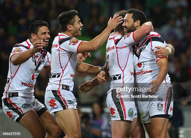 Feleti Mateo of the Warriors is congratulated by his teammates after scoring a try during the round 8 NRL match between the Melbourne Storm and the...