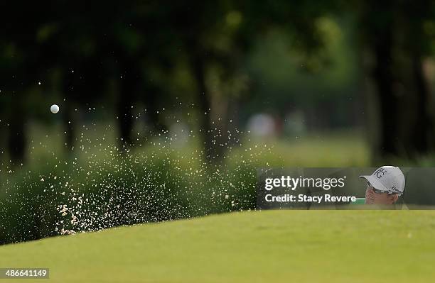 Scott Langley hits out of the bunker on the 11th during Round Two of the Zurich Classic of New Orleans at TPC Louisiana on April 25, 2014 in...