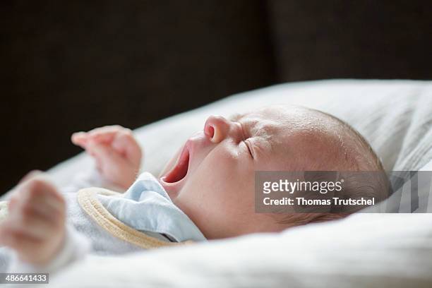 Week old baby is yawning on April 19, in Buecheloh, Germany.