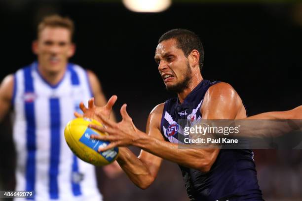 Michael Johnson of the Dockers gathers the ball during the round six AFL match between the Fremantle Dockers and the North Melbourne Kangaroos at...