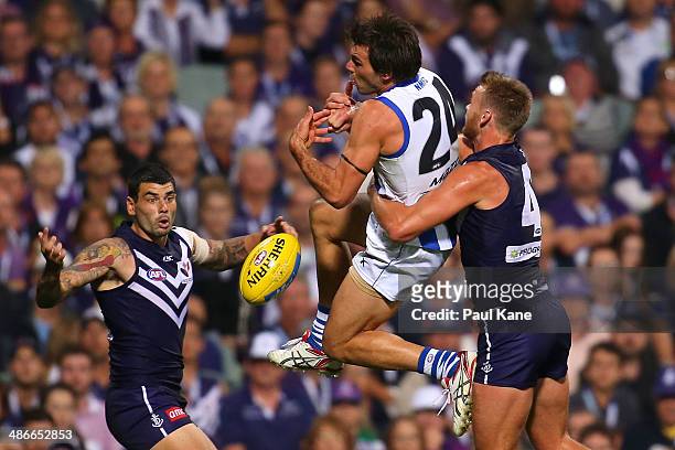 Levi Greenwood of the Kangaroos spills a marks against Paul Duffield of the Dockers during the round six AFL match between the Fremantle Dockers and...