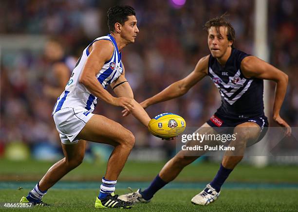 Robin Nahas of the Kangaroos looks to pss the ball during the round six AFL match between the Fremantle Dockers and the North Melbourne Kangaroos at...