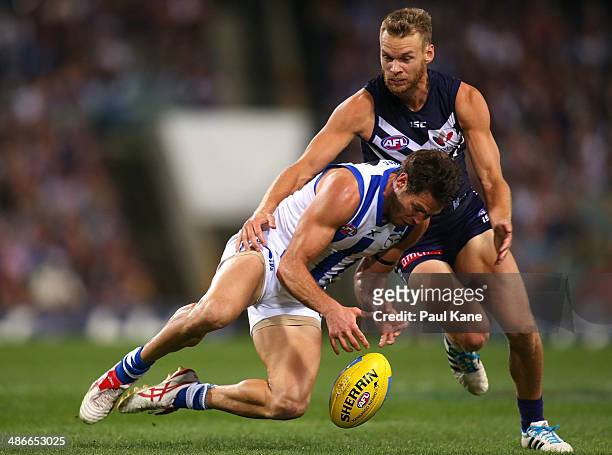 Paul Duffield of the Dockers looks to tackle Sam Gibson of the Kangaroos during the round six AFL match between the Fremantle Dockers and the North...