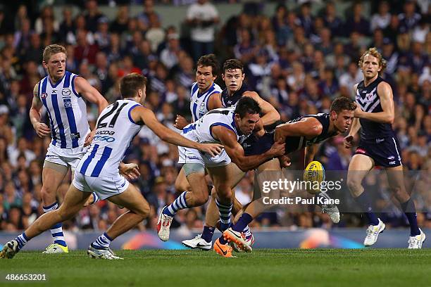 Hayden Crozier of the Dockers attempts to break from a tackle by Michael Firrito of the Kangaroos during the round six AFL match between the...