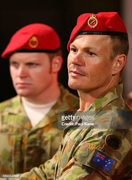 Australian army soldiers look on before entering the field for an Anzac Day tribute during the round six AFL match between the Fremantle Dockers and...