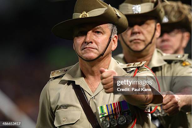 Soldiers match off the field after the one minute silence in tribute to Anzac Day during the round six AFL match between the Fremantle Dockers and...