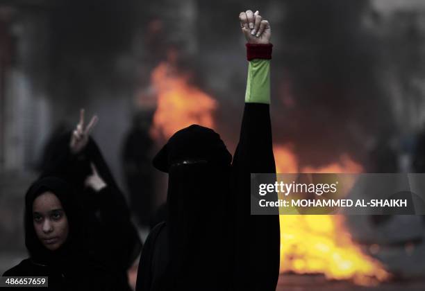 Bahraini women shout slogans during clashes with and riot police following a protest condemning the death of Ahmed Al-Mosajen and Ali Abbas, in the...