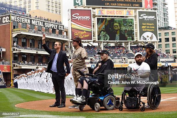 Celebrity actor Gary Sinise and US Marine Corps Sgt. Nick Kimmel with veterans Jerral Hancock of the Army and Juan Dominguez of the USMC on field...