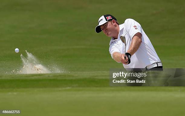 Holmes hits a shot out of the bunker on the 18th during Round Two of the Zurich Classic of New Orleans at TPC Louisiana on April 25, 2014 in...