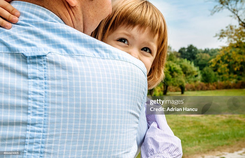 Portrait of a smiling girl hugging her father