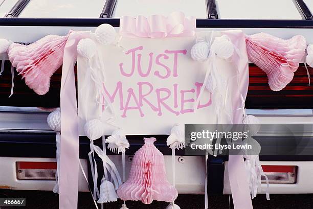 back of car with just married sign - just married stockfoto's en -beelden