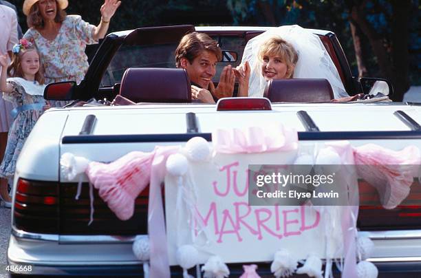 wedding couple driving away in car - just married stock pictures, royalty-free photos & images