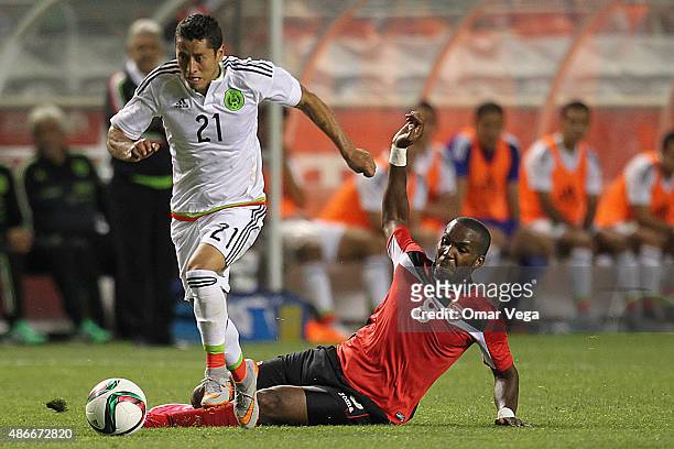 Carlos Esquivel of Mexico dribbles Khaleem Hyland of Tirnidad and Tobago during a friendly match between Mexico and Trinidad and Tobago at Rio Tinto...