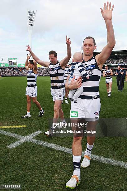 Mathew Stokes of the Cats Steve Johnson and James Kelly wave to the fans after playing their last game for the club during the round 23 AFL match...