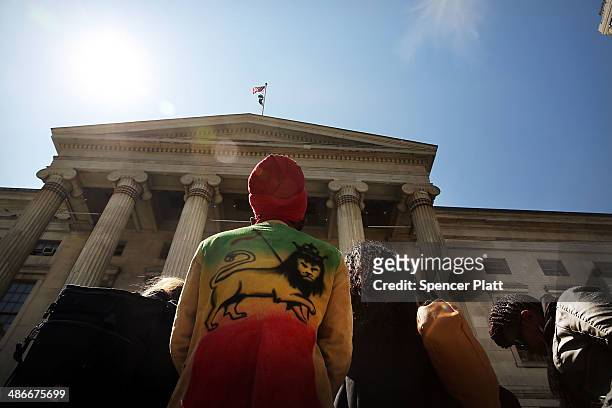 Man stops by a rally outside Brooklyn borough hall in support of the district attorney's plans to end prosecuting minor marijuana offenses on April...