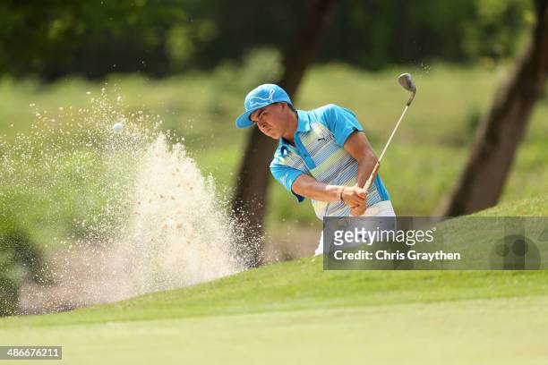 Rickie Fowler chips out of the bunker on the 2nd during Round Two of the Zurich Classic of New Orleans at TPC Louisiana on April 25, 2014 in...